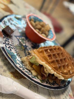 Cheddar waffle with side of potatoes.