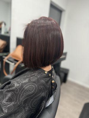 Dark burgundy color and angle bob haircut