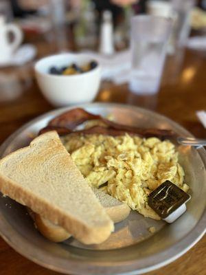 Scrambled eggs, sour dough toast and bacon
