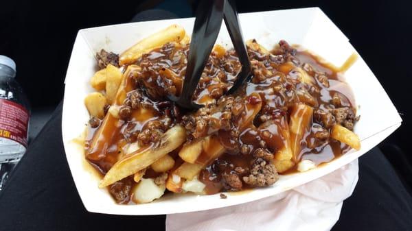 I think it's called the meat lover poutine with caramelized onions, bacon, sausage, curds, and gravy