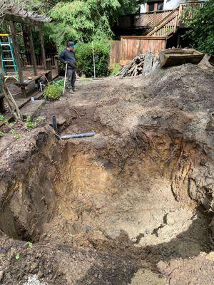 This is the hole. After it was dug, it rained again and they had to pump out the water.