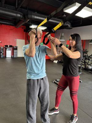 Trainer Deidre assisting Tex bicep work