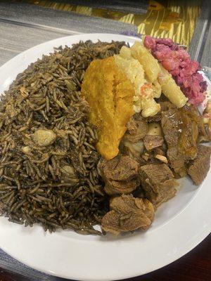 Haitian Black rice with goat, macaroni, and potato salad