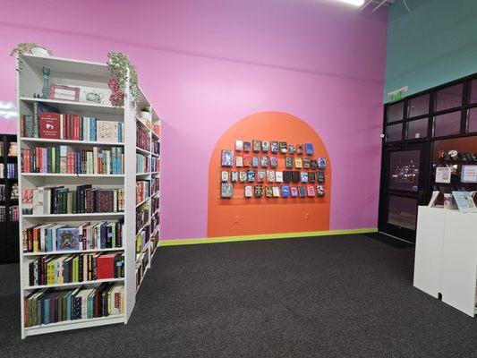 Literary fiction and highlighted books on the wall.