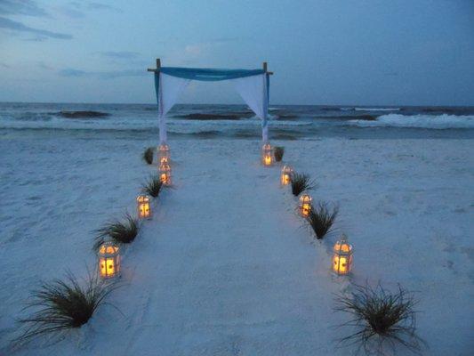 3 pole bamboo arch with lanterns and grass walkway