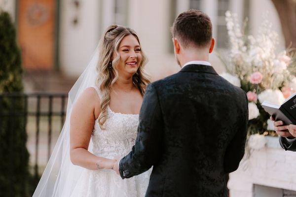 A nervous smile from the bride as her groom makes his vows during their outdoor ceremony at 10 South.