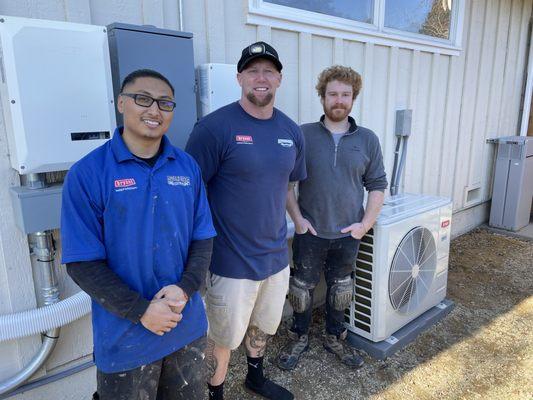 Angel, Charlie and CJ next to our new Bryant Mini Split Heat Pump. We love our clean heat!