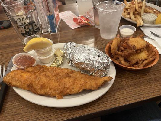 Seafood trip; fish fry plated with a baked potato and a bowl of shrimp and clam strips!