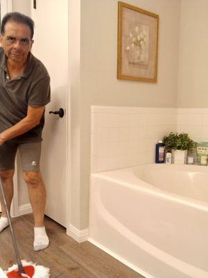 Bathroom floor being mopped.