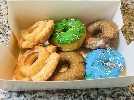 Sour cream donut, frosted donut with sprinkles, blueberry cake donut