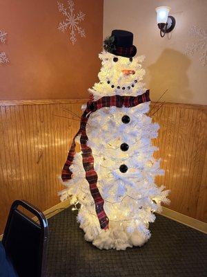 Cute snowman Christmas tree in the corner