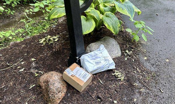 Packages left at the base of mailbox during the rain storm. UDS could be the most laziest provider of delivery service.