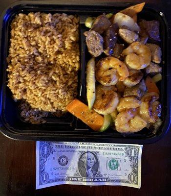 Steak and Shrimp Hibachi w/ a dollar to show size.