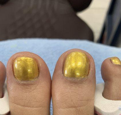 Uneven bumpy application on one tie. Polish not cleaned up around toes.