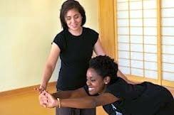 Instructors care for and adjust postures as necessary during classes