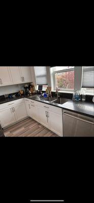 Residents full kitchen cleaning floor cabinets and dusted.