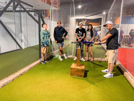 Hitting the golf ball through the net to get to the hole!