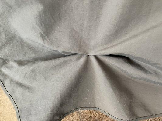 Flap rolls up and snaps. Snap fastened to pull up flap