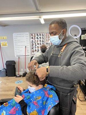 Cutting a kids hair scissors over comb!