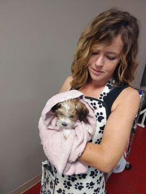 After the pups first bath Terrin is warming him up prepping him for the grooming table. A warm heart in both of them.