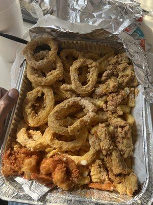 This is the seafood platter with calamari and oysters perfectly seasoned and fried.