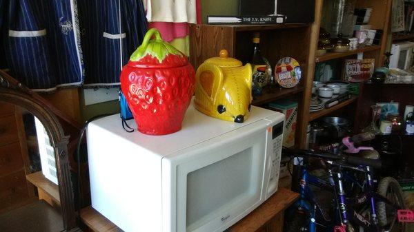 Several cute cookie jars and kitchen items of all kinds.