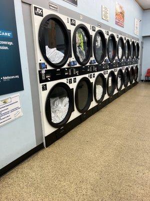 All these dryers with white linen have be sitting done for over 20 minutes. This is stuff the staff is washing for outside clients