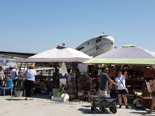 Antiques on the tarmac, along with an antique plane.