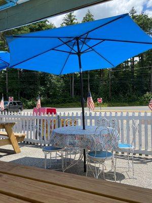 Tables with plenty of shade for eating ice cream on a hot summer day.