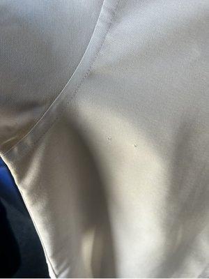 Shirt appeared like it was pulled through machinery, dark brown dingy all over.