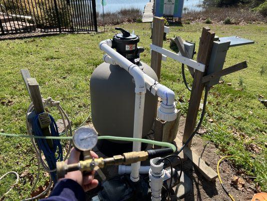 Pressure testing a pool's plumbing to identify if the leak is in their plumbing and not the liner.