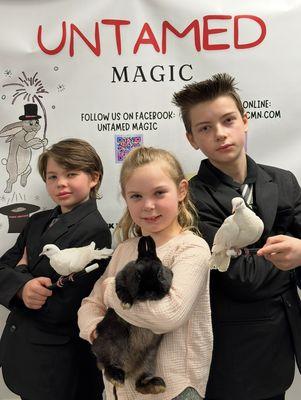3 of Minnesota's Youngest Professional Magicians holding their magical animal assistants.