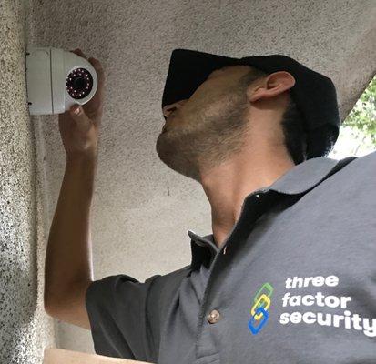 Professional Installer getting the perfect angle on a Dome security camera installation at a lovely location in Malibu, California