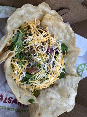 Some meat in a taco shell bowl. Has other crap in it like cheese, beans, lettuce and other stuff.