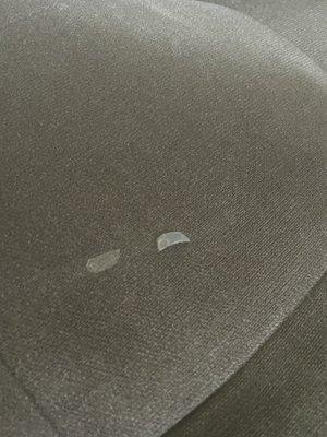 A sticker was on the seat cushion that came up when I rubbed my hand a crossed . You can see where the sticker was by the dry spot