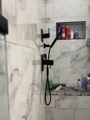 View after new plumber anchored handles to wall appropriately, but rough-in was crooked in wall causing handles to still be crooked.