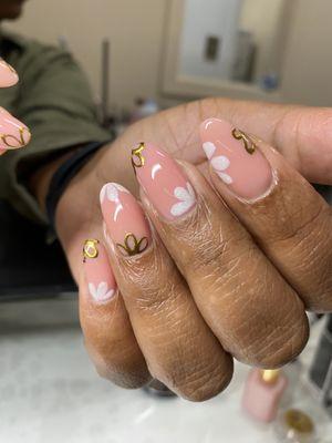 Gel overlay on natural nails with gold chrome and white flowers