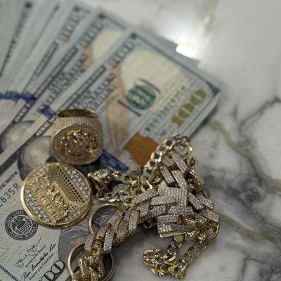 Gold pendant, ring, bracelet and chain being sold for cash.