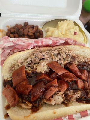 Pulled pork sandwich with a SPIKE (hot link) bbq baked beans and potato salad