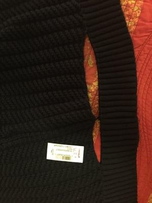 I was not told about the massive tear in the back of the sweater I just purchased. Didn't find out until I got home.
