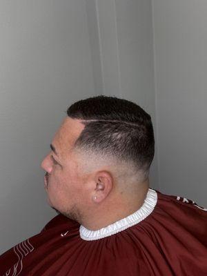 Stylish combover with a mid razor fade and crisp razor line-up, a sharp, polished look with timeless appeal and modern edge.