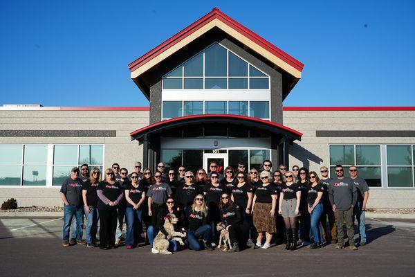 Team photo in front of office