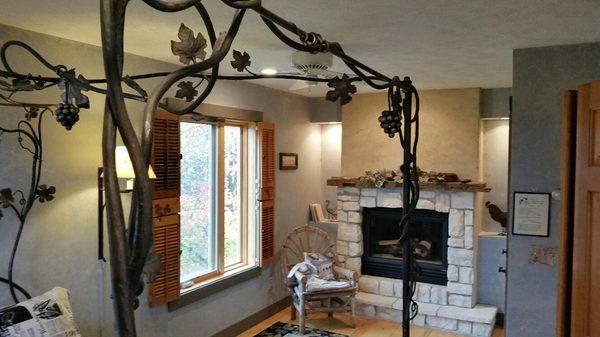 Barnwood room custom designed wrought iron bed in the shape of a grapevine trellis