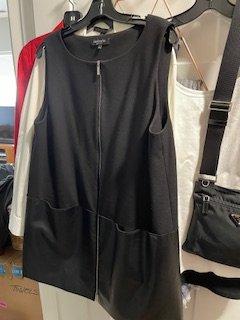 The Full Vest - Wool w/"Fake" Leather! I also bought a jacket with the wool and real leather panels for roughly $500+. It is wearing well.