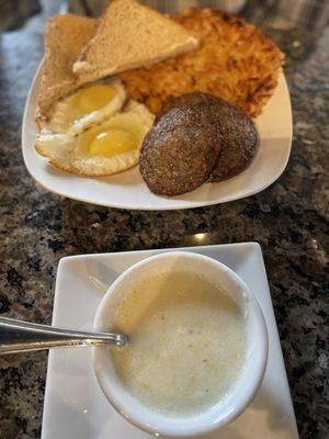 Breakfast platter with sausage, eggs, toast, grits, and hashbrowns.