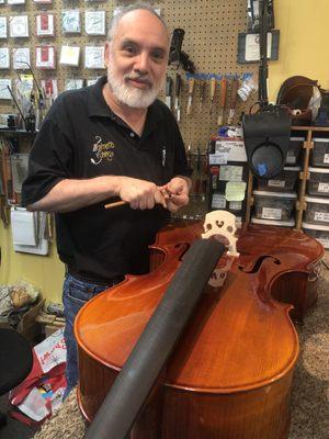 Michael Reisman adjusting a cello soundpost before setting.