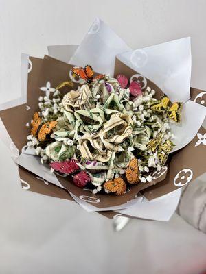 Real money roses with faux butterflies and baby's breath hand tied bouquet.