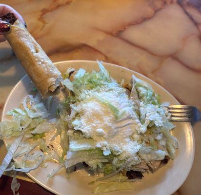 Beef taquitos with lettuce, house salsa, and cotija cheese.