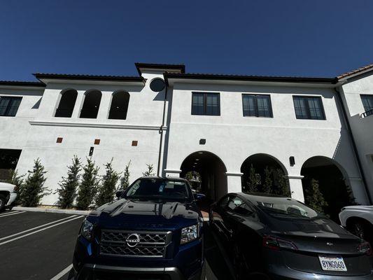 Enter through the back parking lot