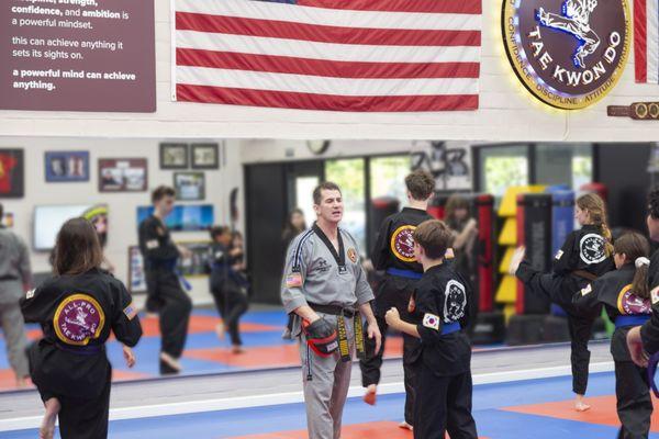 Founder & Owner Grandmaster Fanelli teaching a pre-teens & teens group class.